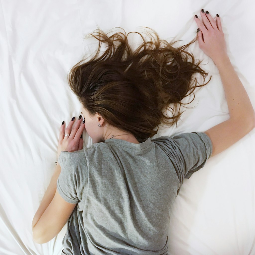 Woman laying on bed comfortably