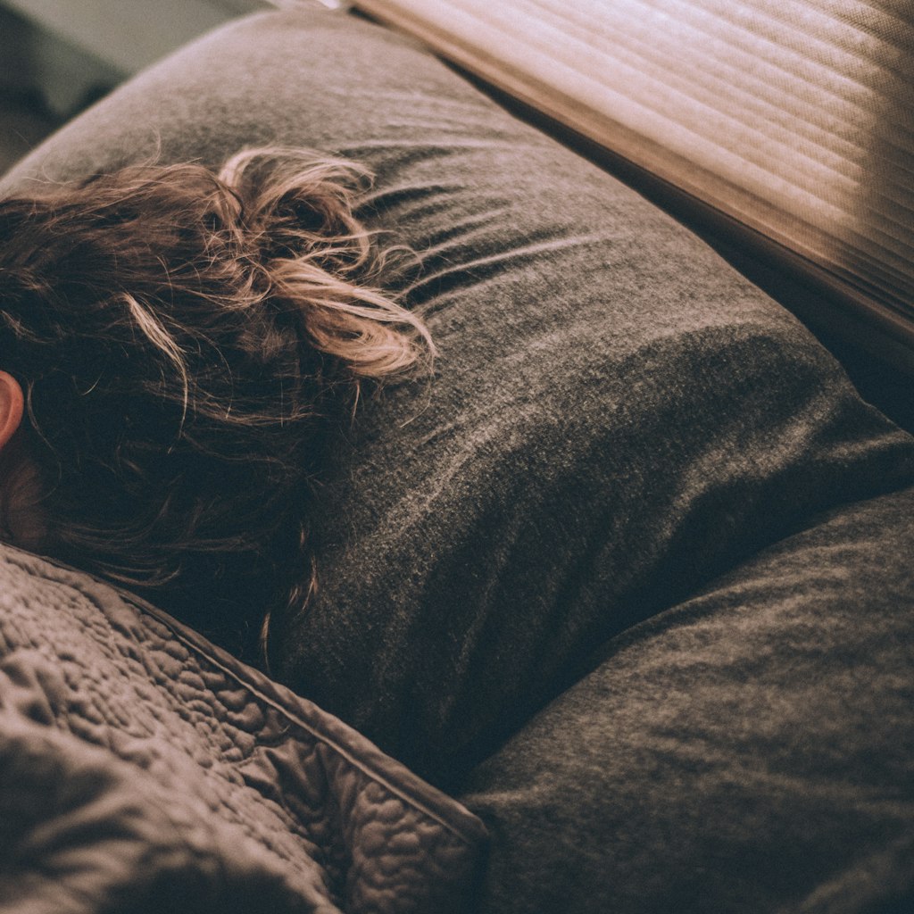 Woman sleeping peacefully on bed
