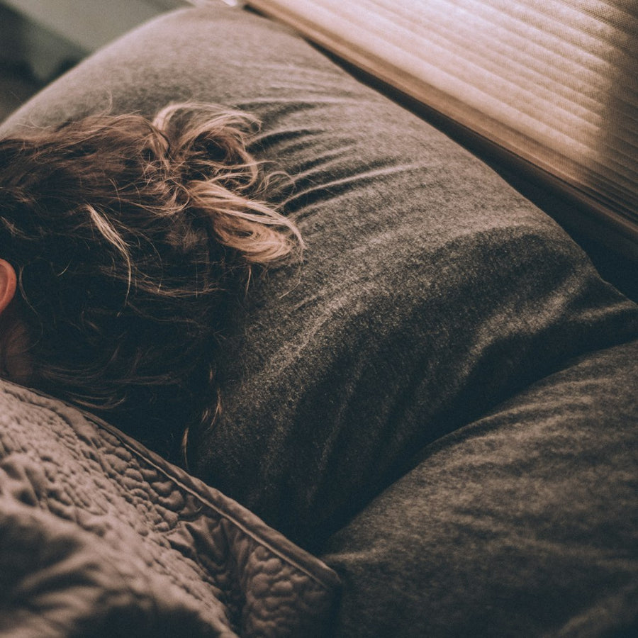 Woman sleeping peacefully on bed